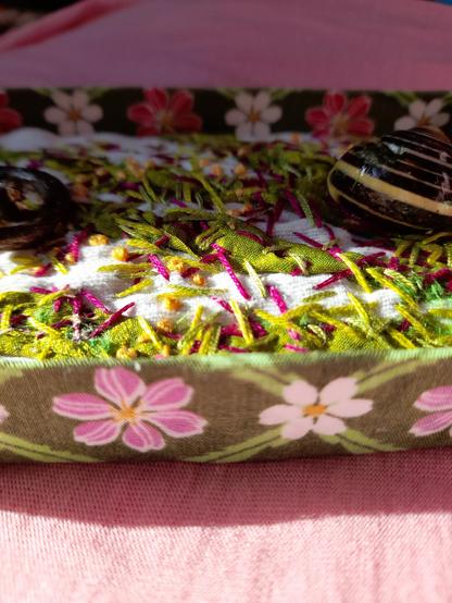 Another detail showing the fabric on the box. It's green with white and pink flowers.