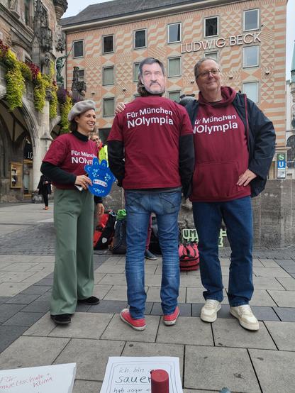 3 Demonstranten mit Shirts an mit Aufschrift: Für München NOlympia